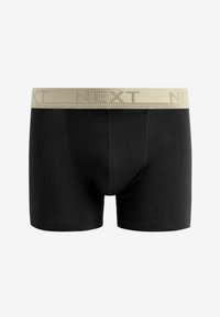Schwarze Baumwoll-Boxershorts mit einem beigen elastischen Bund, der mit dem Schriftzug "NEXT" versehen ist. Glatte Textur ohne sichtbare Muster. Klassische Form.