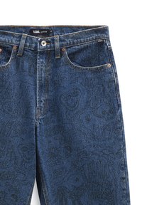 Jean en denim bleu avec des motifs noirs de style gribouillage, incluant des visages souriants, des mains et du texte, avec un branding Vans sur la ceinture et la poche.