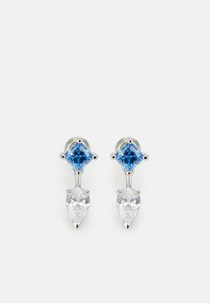 Silver-tone earrings featuring a square blue stone on top and a pear-shaped clear stone below, connected by a thin metal link.