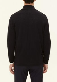 Black knit sweater with a mock collar, long sleeves, and ribbed cuffs. Textured fabric with a smooth finish, viewed from the back.