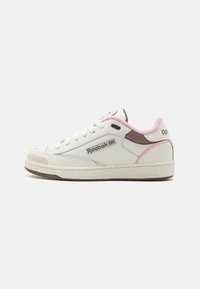 Sneaker in pelle bianca con accenti rosa e marrone, punta rotonda, design classico con lacci e suola in gomma testurizzata. Logo Reebok sul lato.