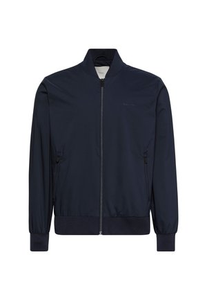 Tengerészkék bombázódzseki könnyű, sima anyagból. Cipzáras elülső rész, bordázott mandzsetták és alsó szegély, valamint oldalzsebek jellemzik. Minimális márkajelzés a mellrészen.