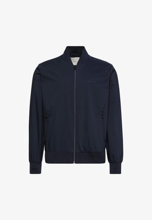 Ναυτικό μπουφάν βομβιστή από ελαφρύ, λείο ύφασμα. Διαθέτει φερμουάρ μπροστά, ριμπ μανσέτες και τελείωμα, καθώς και πλαϊνές τσέπες. Ελάχιστη σήμανση στο στήθος.