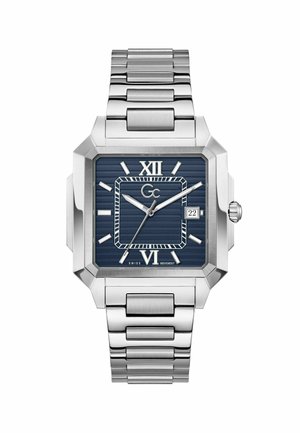 Orologio da polso quadrato in metallo argento con quadrante blu, numeri romani a ore 12 e 6, finestra della data a ore 3 e cinturino a maglie.