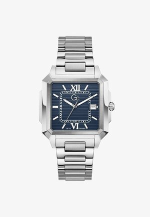 Štvorec hodinky z strieborného kovu s modrým ciferníkom, rímskymi číslicami na pozíciách 12 a 6, okienkom s dátumom na 3 a prepojeným náramkom.