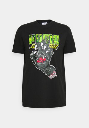 Czarna bawełniana koszulka z grafiką przedstawiającą łapę z pazurami i czerwoną językiem, z jaskrawą zieloną napisem "PUMA" powyżej. Krótkie rękawy, okrągły dekolt.