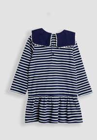 Jūrų jūrlinijos dryžuota suknelė su ilgomis rankovėmis, apvaliu apykakle ir banguotu kraštu. Turi mygtukų uždarymo detalę nugaros pusėje ir įšalusią sijoną.