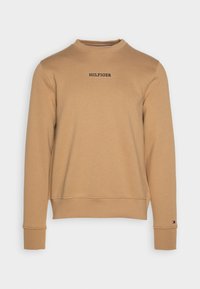 Sweatshirt marrone con colletto rotondo, caratterizzato da un piccolo logo nero sul petto. Realizzato in un tessuto morbido con polsini e orlo a costine.