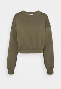 Sudadera verde oliva recortada con mangas largas, puños acanalados y una cintura elástica. Fabricada en un suave material de algodón texturizado.