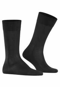 Czarne skarpetki wykonane z gładkiego, elastycznego materiału z prążkowanymi ściągaczami. Projekt obejmuje wzmocnioną strefę palców i pięty dla większej trwałości.