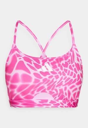 Sports bra in pink with a multicolor abstract pattern. Features thin, crisscross straps and a small white logo on the front. Made of stretchy material.