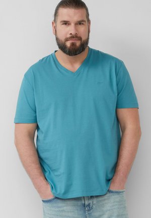 Turquoise V-neck T-shirt made from soft fabric, featuring short sleeves and a relaxed fit. Subtle branding on the chest.