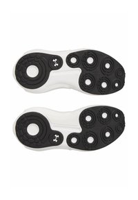 Semelles de chaussures de sport en noir et blanc avec des motifs arrondis et des textures variées, présentant des points de prise circulaires et un logo Under Armour.