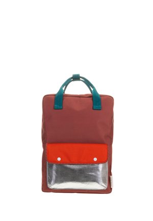 Sac à dos rectangulaire couleur grenat avec des poignées bleu sarcelle, une poche à rabat orange et une poche inférieure argentée brillante sur fond blanc.