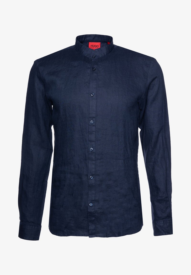 Chemise bleu marine à manches longues, à boutons, avec un col montant et des boutons visibles de haut en bas.