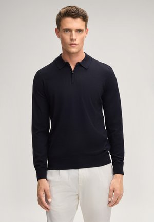 Dunkelblau gestrickter Pullover mit Reißverschlusskragen, langen Ärmeln, gerippten Bündchen und Saum. Der Stoff ist glatt, leicht und weich.