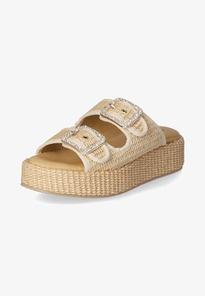 Beige platform sandals with woven texture, two wide straps featuring decorative silver buckles, and a cushioned footbed.