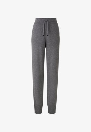 Grå sweats, lavet af blødt stof, med en elastisk talje med snøre, ribbede manchetter og sidelommer med accenter.
