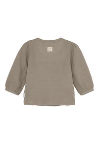Langsleeve geribbelde peuter T-shirt in gedempt beige met elastische manchetten en een klein logo met een kattenkop op de bovenrug.