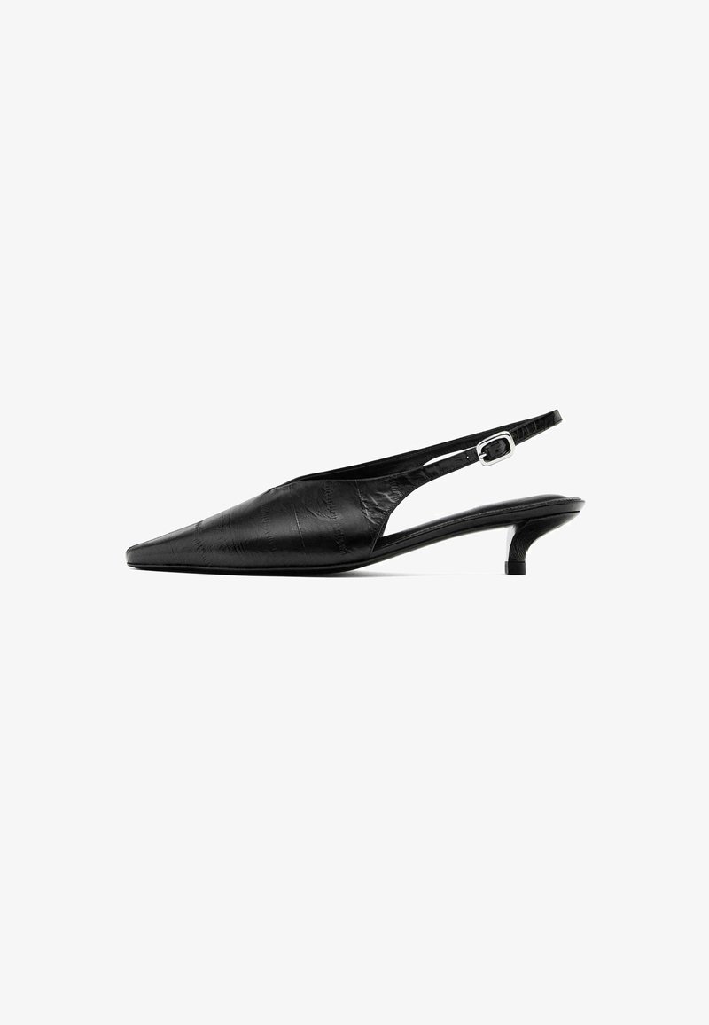 Black slingback heels with a pointed toe, textured leather upper, slender heel, and adjustable buckle strap.