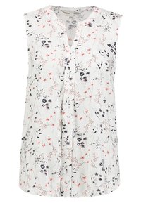 Vit ärmlös blus med V-ringning och rosa och svarta blommönster spridda över tyget.