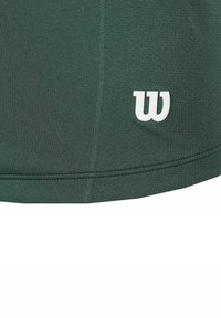 Groene sporttop van textuurstof, met een wit "W"-logo en een naadloos ontwerp met een ronde zoom.