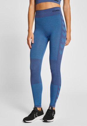 Blue athletic leggings with a textured design, featuring varying shades of blue and chevron accents on the side. Elastic waistband.