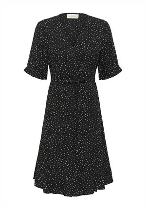 Schwarzes Wickelkleid mit weißen Punkten, kurzen Puffärmeln, V-Ausschnitt und Bindeband in der Taille. Hat einen ausgestellten Saum und ist aus leichtem Stoff.