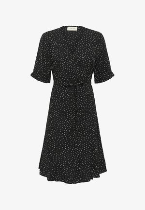 Svart omslagskjole med hvite prikker, korte pufferm, V-hals og belte i midjen. Har en flagrende hemline og lett stoff.