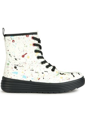 Hiking boots with a white splatter-painted upper, black rubber sole, and black laces. Features colorful paint splashes and a tapered design.