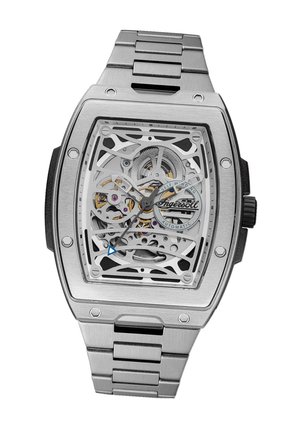 Montre automatique squelette avec un boîtier rectangulaire en acier inoxydable, bracelet en acier argenté et un mouvement visible complexe avec des accents dorés.