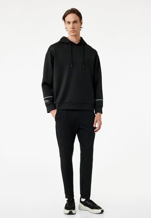 Pantalones deportivos - black