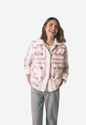 Fleecejacke in Weiß mit pinken Blumenmustern und geometrischen Akzenten, ausgestattet mit durchgehender Knopfleiste und spitzem Kragen.