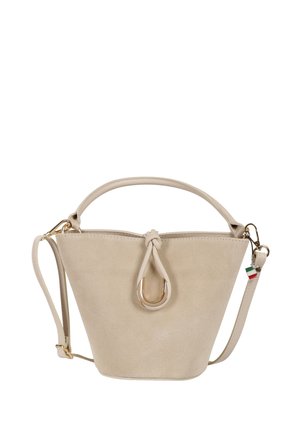 Sac seau en daim beige avec poignée supérieure, bandoulière amovible et fermoir en forme de U doré avec détail nœud.