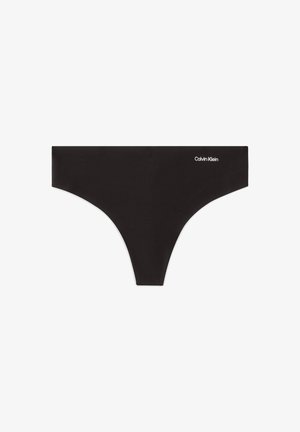 String-tanga noir sans couture avec petit logo Calvin Klein blanc sur le côté droit à l'avant.