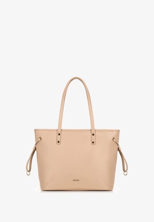 Beige synthetische tote bag met twee lange handgrepen, gouden hardware accenten en trekkoorddetail aan de zijkanten. Glad oppervlak, minimalistisch ontwerp.