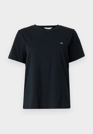 Juoda medvilninė marškinėliai su trumpomis rankovėmis, apvaliu kaklu ir mažos detalės su logotipu siuvinėtos kairėje krūtinės pusėje. Klasikinis, laisvas kirpimas.