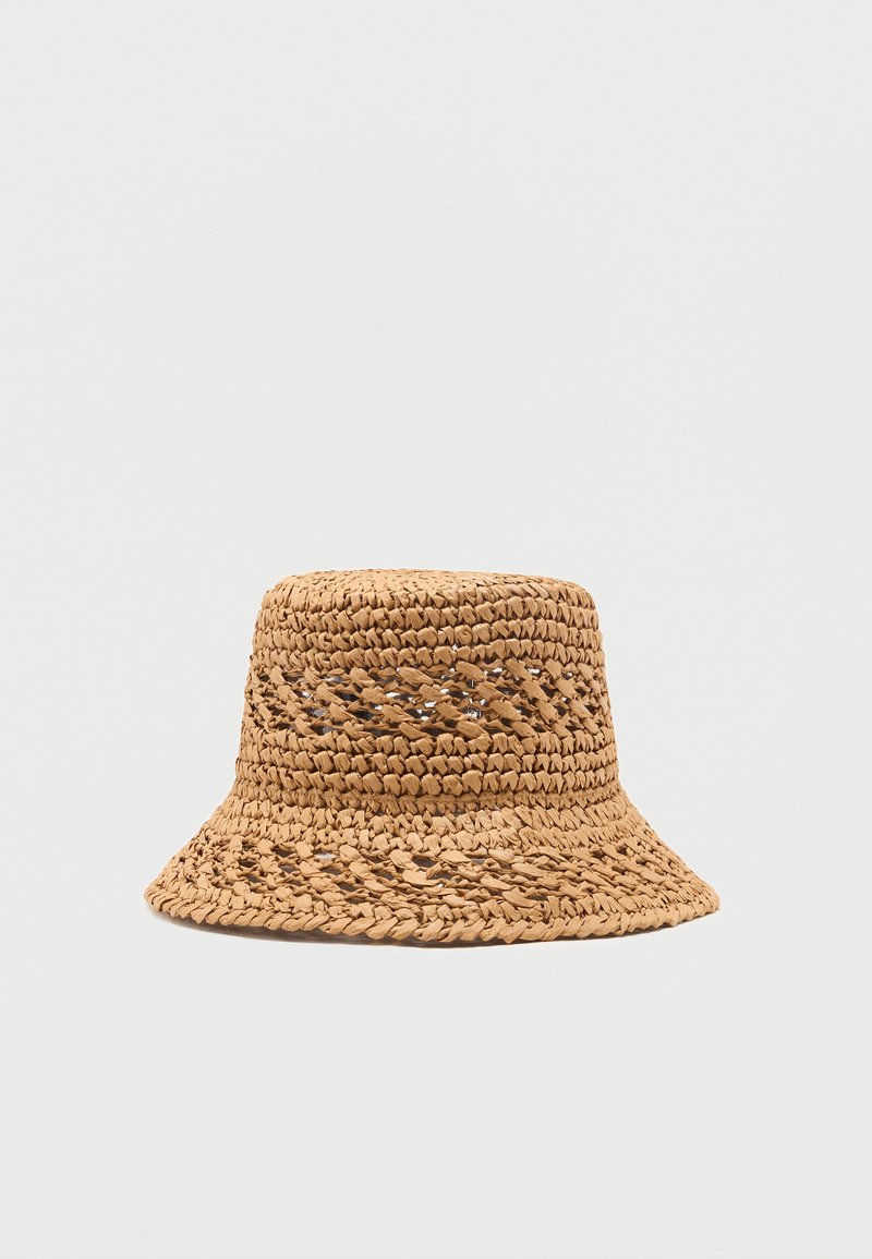 Chapeau seau en paille tannée tissée avec un motif décoratif en tissage ouvert autour de la calotte et du bord.