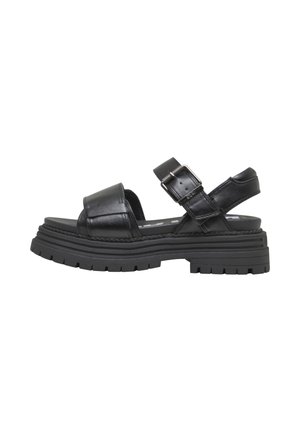 Black leather sandals with a thick, textured sole, adjustable buckle strap, and open-toe design. Smooth finish with minimal stitching details.