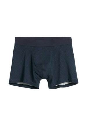 Laivastonsiniset bokserishortsit geometrisellä kuviolla, pehmeää kangasta ja tumma joustava vyötärönauha. Sisältää muotoillun pussin istuvuutta varten.