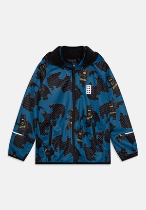 Veste bleue pour enfant avec logos Batman en motif brique noire et figurines LEGO Batman, fermeture éclair noire, et capuche.
