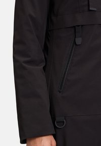 Černá voděodolná bunda s hladkou strukturou, vybavená kapsou na zip a nastavitelným páskem na lemu.