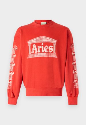 Sweatshirt rouge à col rond, avec un graphisme blanc représentant une colonne et le mot "Bélier" à l'avant et sur les manches. Le tissu est en coton doux.