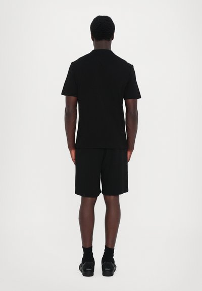 Black short-sleeve t-shirt and shorts outfit, made of cotton, featuring a simple design with a relaxed fit and no visible patterns or accents.