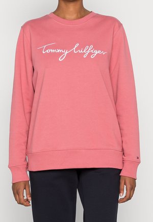 Sudadera de algodón rosa con puños y dobladillo acanalados, que presenta el logotipo bordado en blanco "Tommy Hilfiger" en el pecho.