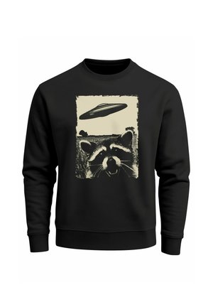 Black sweatshirt features a graphic of a raccoon with an alien spaceship above it, displayed in a distressed cream-colored design.