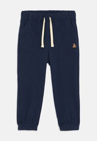 Pantaloni sportivi blu navy con vita elastica e cordoncino. Presentano due tasche anteriori e un piccolo dettaglio ricamato a forma di orso sul lato.