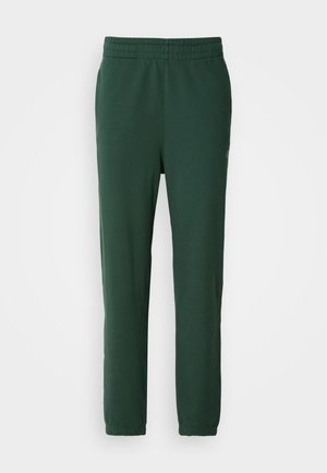 Pantalons de jogging verts en coton doux. Dotés d'une taille élastique et de jambes fuselées, avec un petit logo sur le côté inférieur.