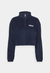 Marineblå kortfleece-pullover med kvartdragkedja och elastiska ärmslut, med en liten vit Adidas-logga på bröstet.