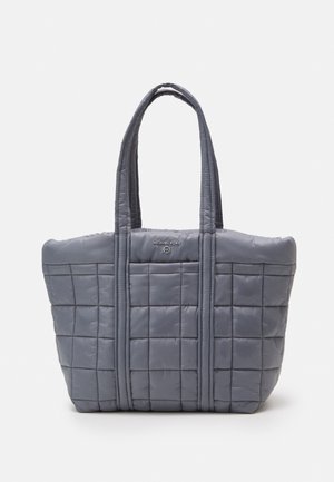 Quilted gray tote bag with two sturdy handles and a small logo detail. Made from padded nylon, featuring a rectangular shape and smooth texture.